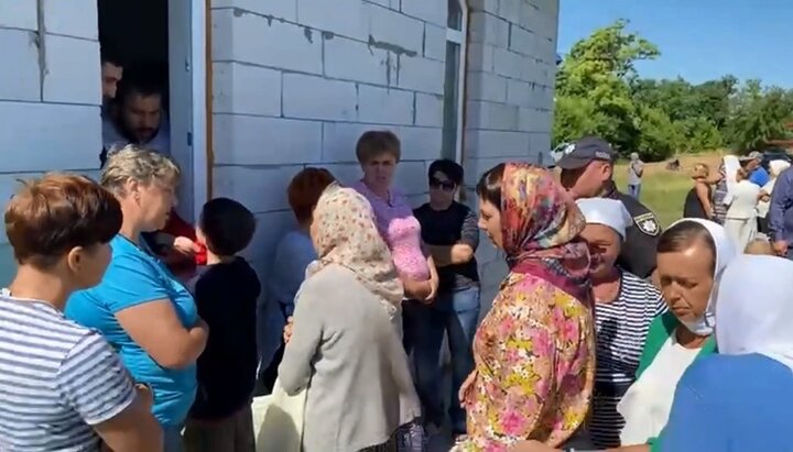 In Kononivka, priest have to give communion to believers through a window