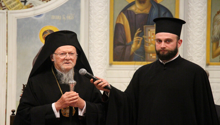 Patriarch Bartholomew speaks to members of YAL as Patriarchal Deacon Barnabas Grigoriadis holds the microphone.