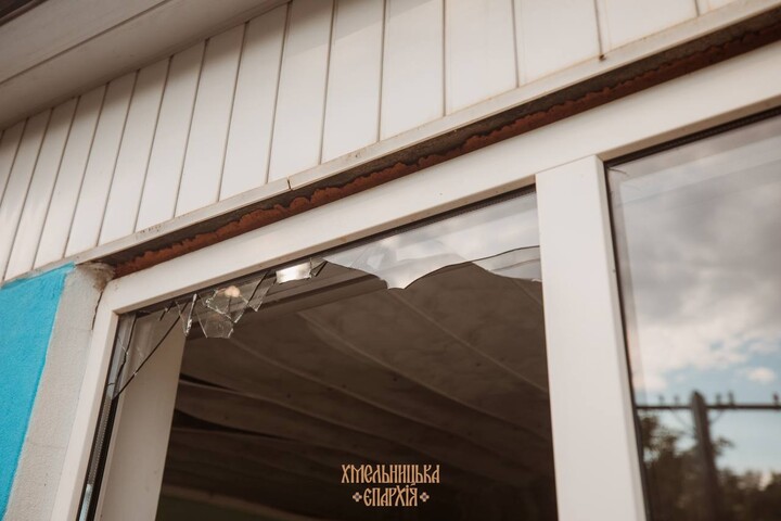 shattered window of the house church